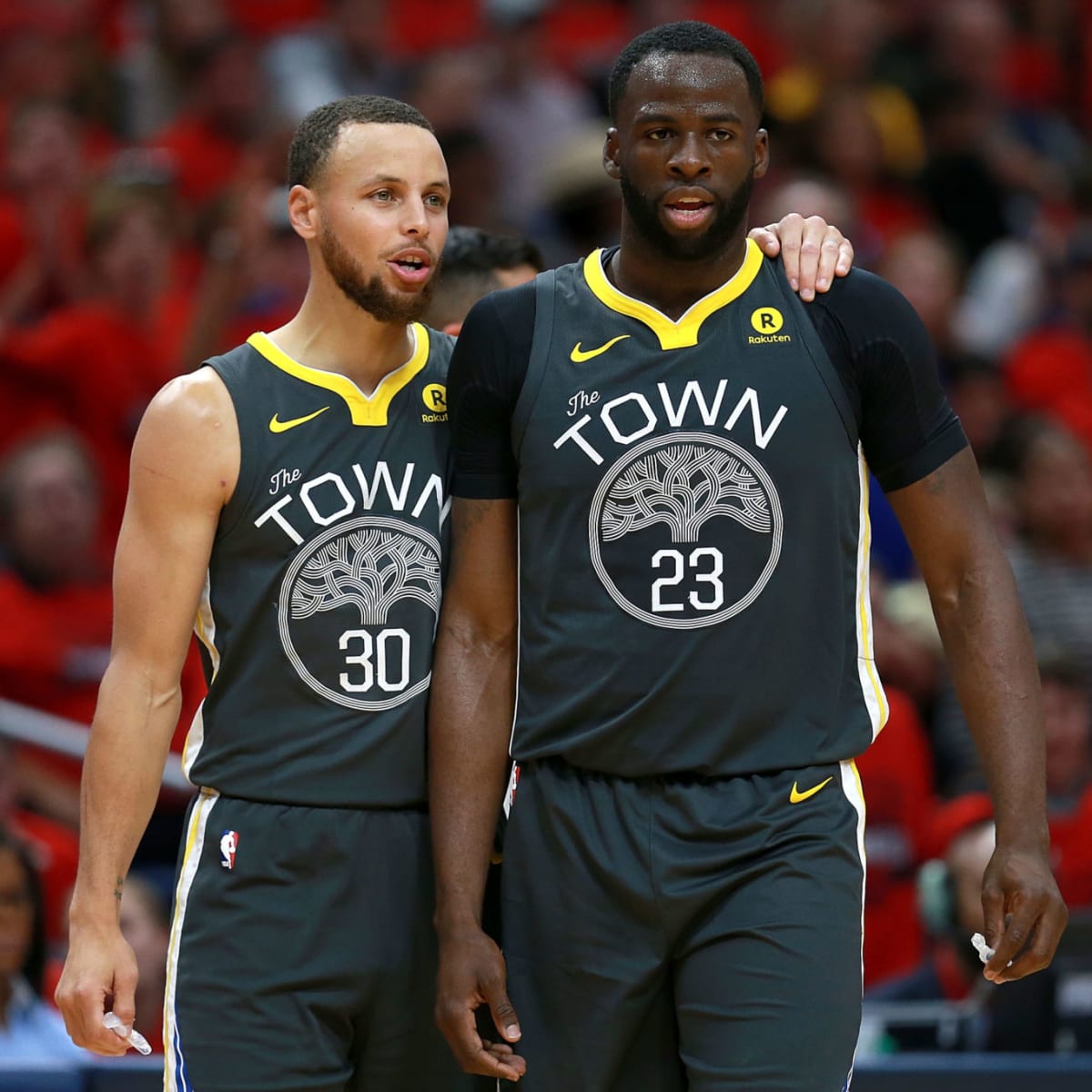 Stephen Curry and Draymond Green of the Golden State Warriors share feedback on the court (photo by Sean Gardner/Getty Images).